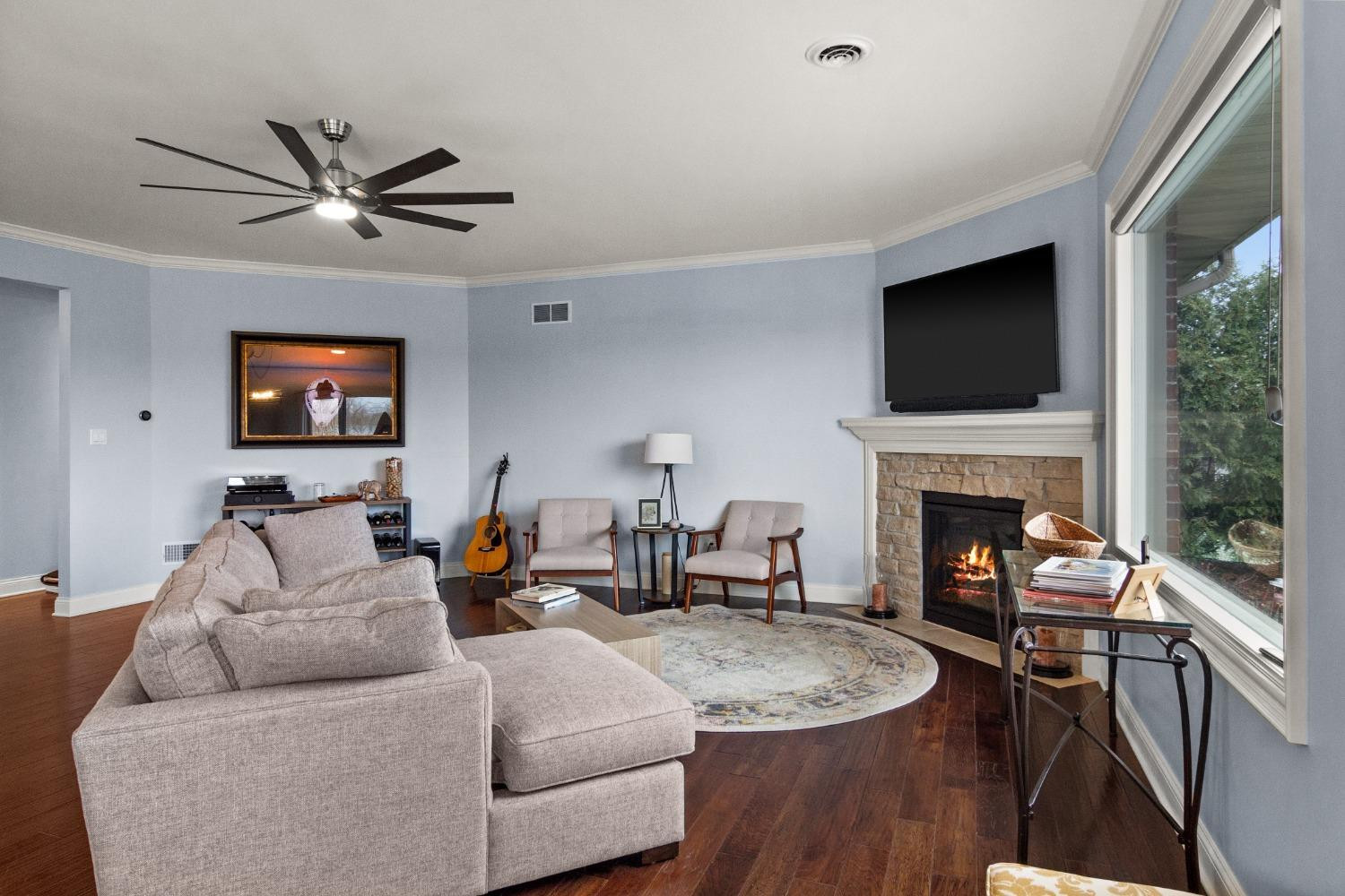 8415 Dancing Waters Lane St. John, IN 46373 - Photo 13 of 31 a living room with furniture a fireplace and a flat screen tv