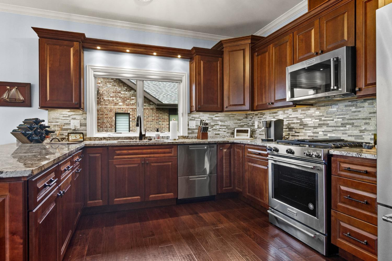 8415 Dancing Waters Lane St. John, IN 46373 - Photo 15 of 31 a kitchen with stainless steel appliances granite countertop a stove microwave and sink