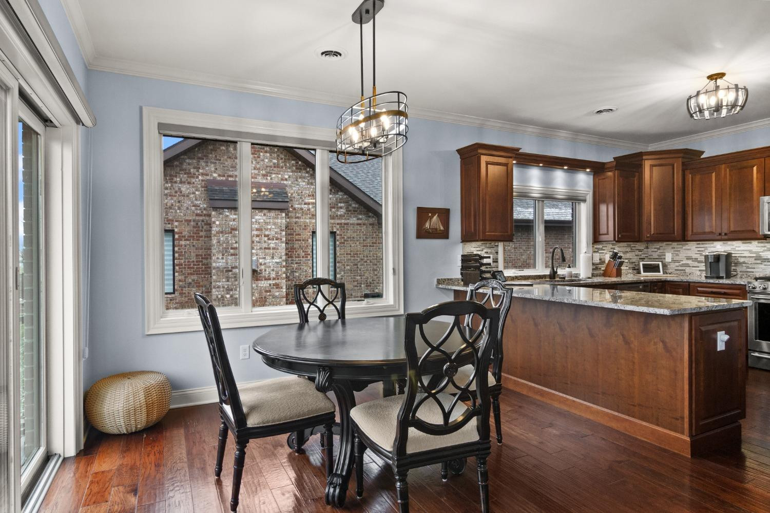 8415 Dancing Waters Lane St. John, IN 46373 - Photo 16 of 31 a view of a dining room with furniture window and wooden floor
