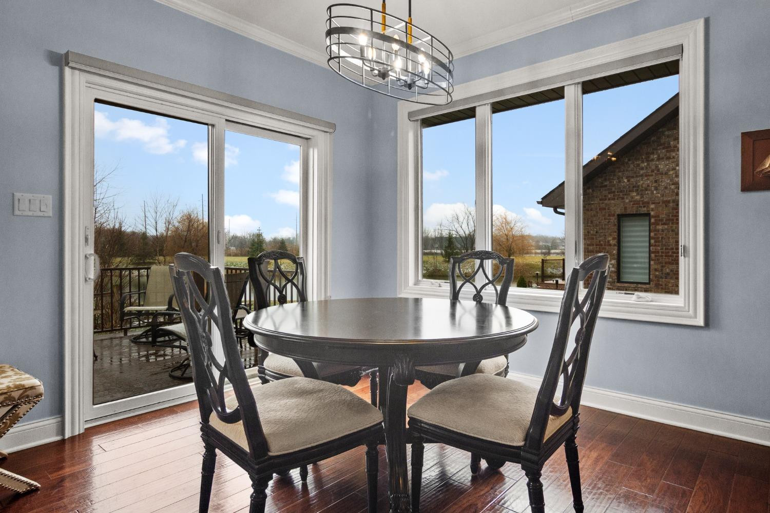 8415 Dancing Waters Lane St. John, IN 46373 - Photo 17 of 31 a dining room with furniture a chandelier and wooden floor