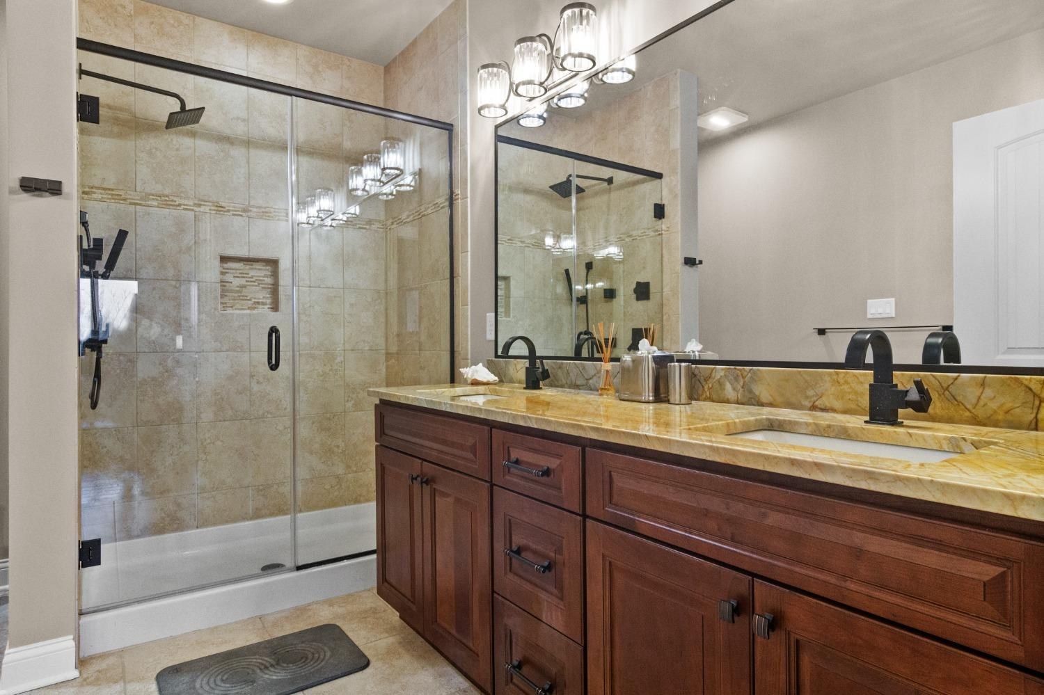 8415 Dancing Waters Lane St. John, IN 46373 - Photo 19 of 31 a bathroom with a double vanity sink mirror and shower