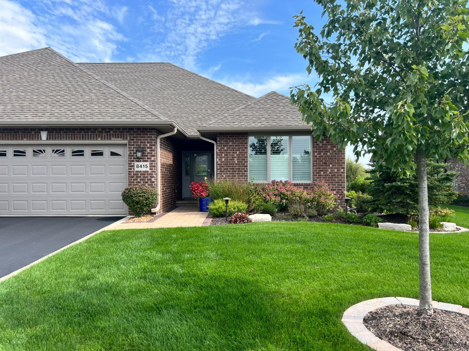 8415 Dancing Waters Lane St. John, IN 46373 - Photo 2 of 31 a front view of a house with a garden
