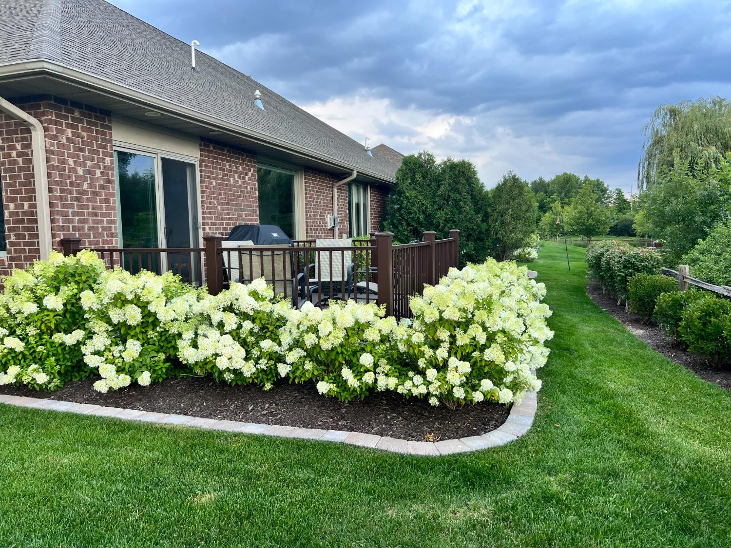 8415 Dancing Waters Lane St. John, IN 46373 - Photo 26 of 31 a bunch of flowers in front of house