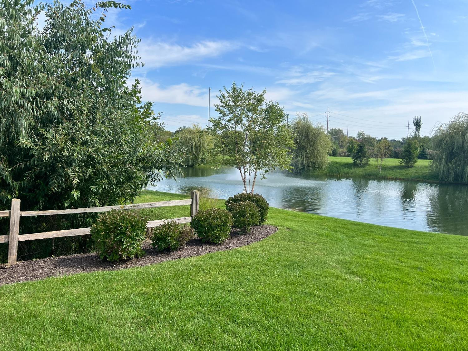 8415 Dancing Waters Lane St. John, IN 46373 - Photo 4 of 31 a view of a lake with a yard and large trees