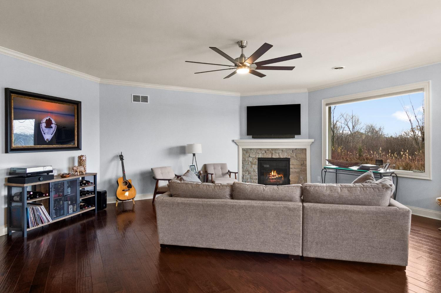8415 Dancing Waters Lane St. John, IN 46373 - Photo 10 of 31 a living room with furniture a flat screen tv and a fireplace