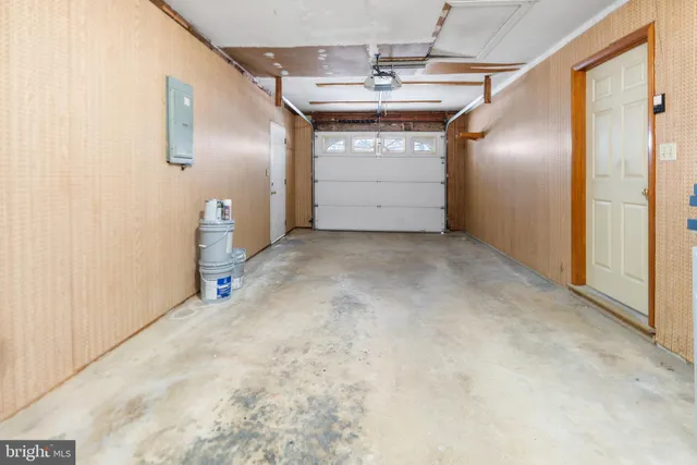 a view of a hallway with wooden walls