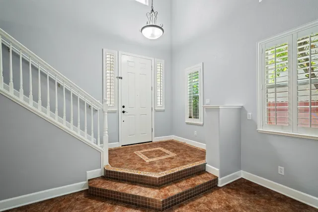 a living room with wooden floor and a window