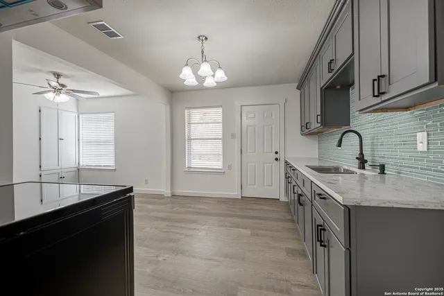 a kitchen with a sink stove and cabinets