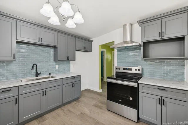 a kitchen with a sink and cabinets