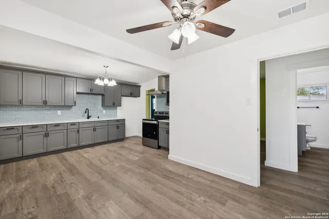 a large kitchen with kitchen island a sink stainless steel appliances and cabinets