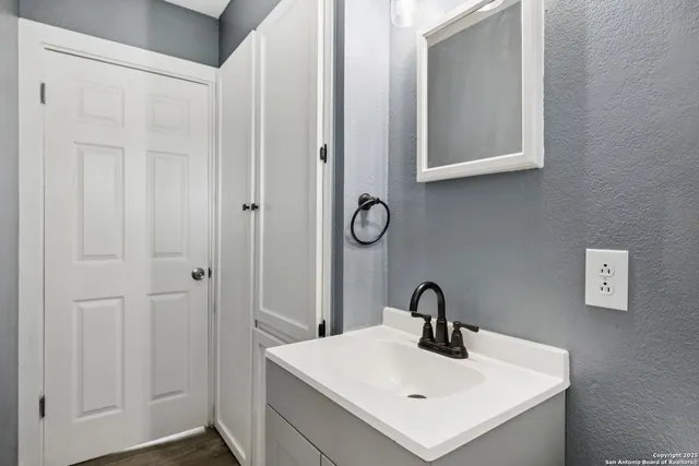 a white sink sitting under a bathroom next to a window