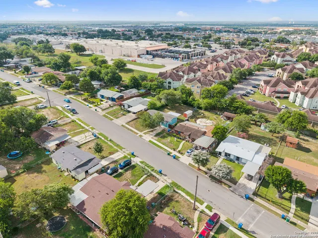 an aerial view of residential houses with outdoor space