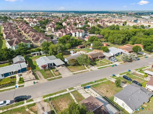 an aerial view of residential houses with outdoor space