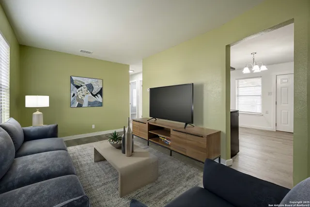 a living room with furniture and a flat screen tv