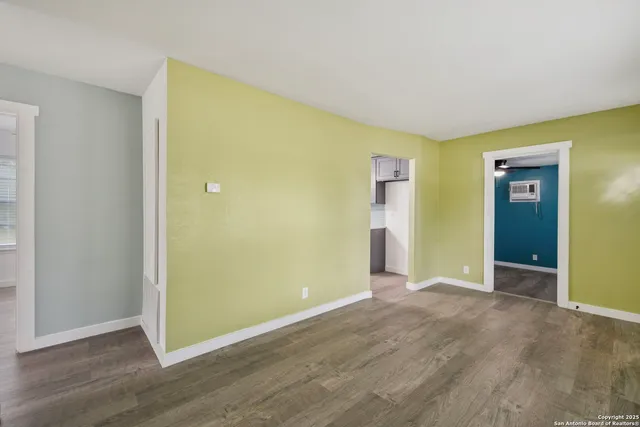 an empty room with wooden floor and closet