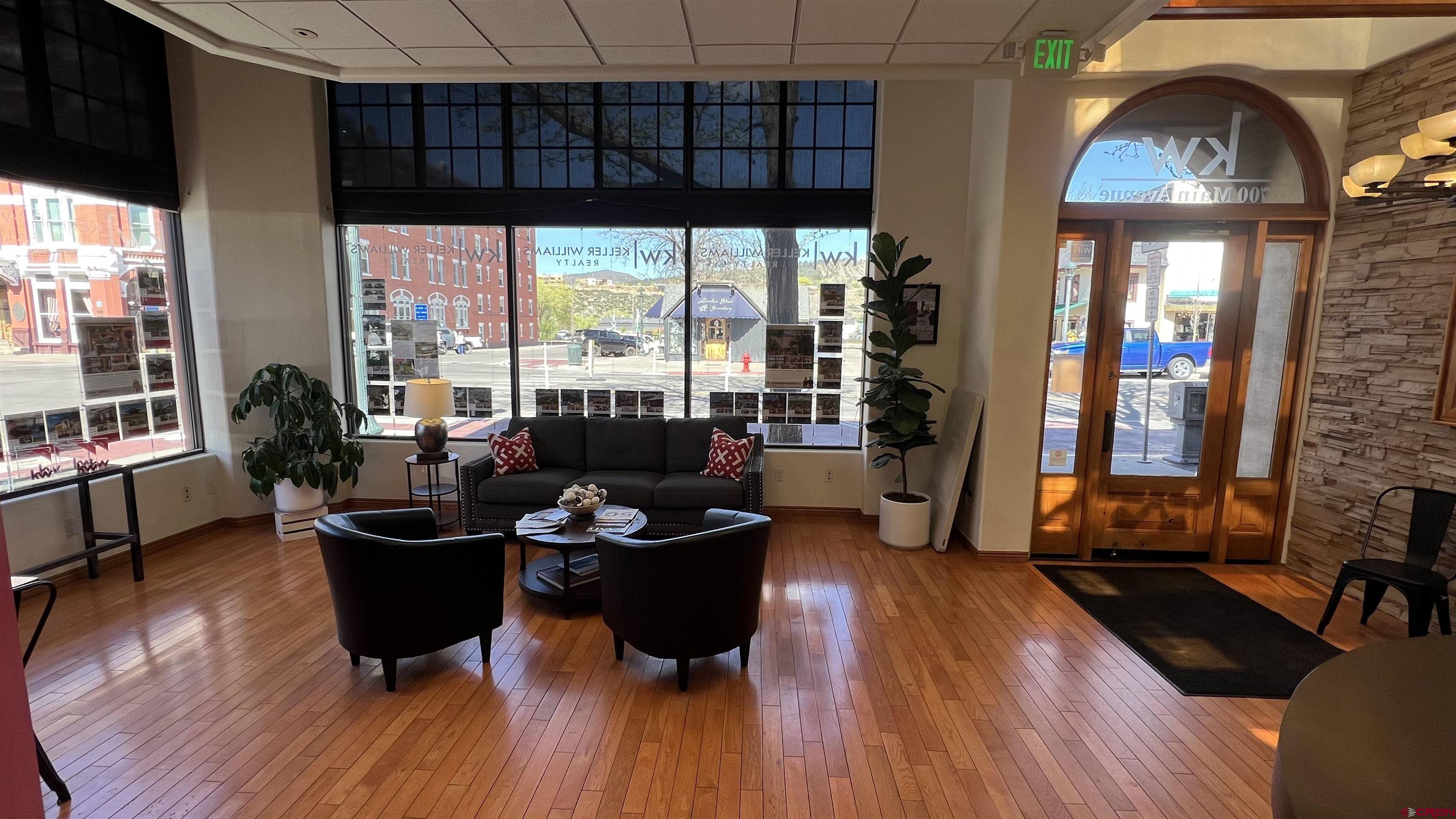 700 Main Avenue, Unit D Durango, CO 81301 - Photo 10 of 13 a living room with furniture floor to ceiling window and wooden floor