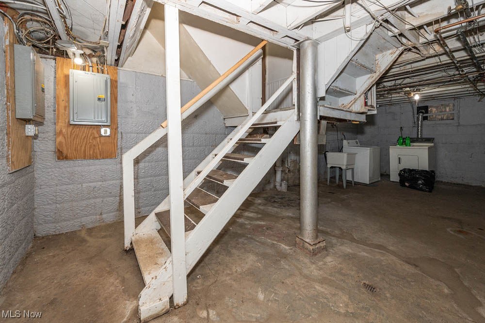 3114 Neosho Road Youngstown, OH 44511 - Photo 22 of 25 Unfinished below grade area with stairs, electric panel, and separate washer and dryer