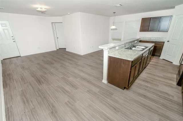 a view of hallway with wooden floor