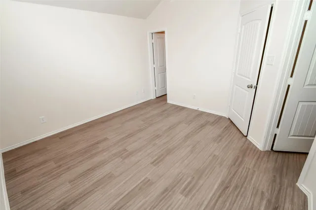 a view of a kitchen with wooden floor and electronic appliances