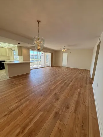 a view of an empty room with a window and fireplace