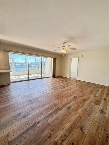 a living room with hard wood floors and a flat screen tv