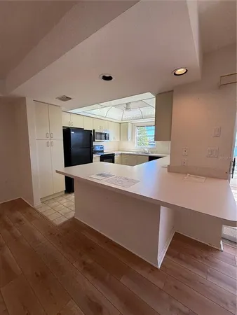 a kitchen with stainless steel appliances granite countertop a sink and cabinets