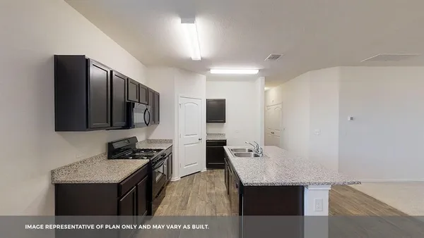 a kitchen with stainless steel appliances a stove microwave and refrigerator