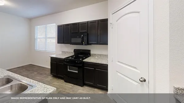 a kitchen with a stove and a microwave