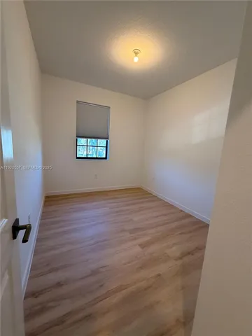 a bathroom with a granite countertop toilet sink mirror and vanity