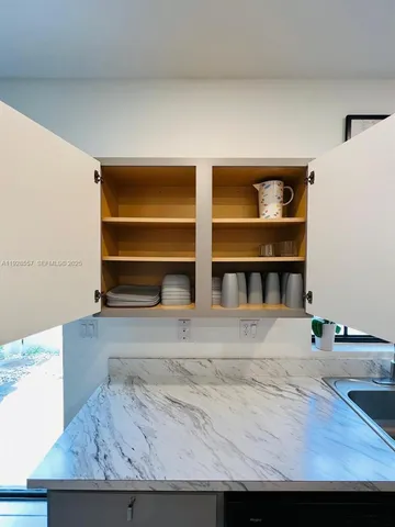 a view of room with wooden floor and cabinet