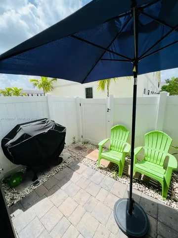 a view of a patio with table and chairs potted plants with wooden floor