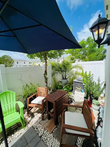 a kitchen with stainless steel appliances kitchen island granite countertop a refrigerator and a sink