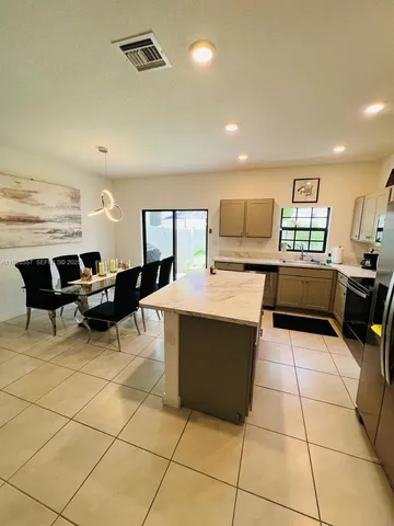 a black leather chair sitting in a living room
