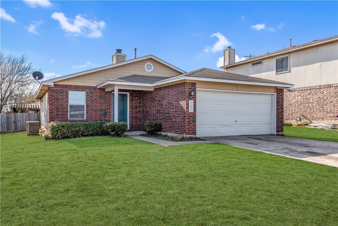 241 Spring Branch Drive Kyle, TX 78640 - Photo 1 of 1 a front view of a house with a yard and garage