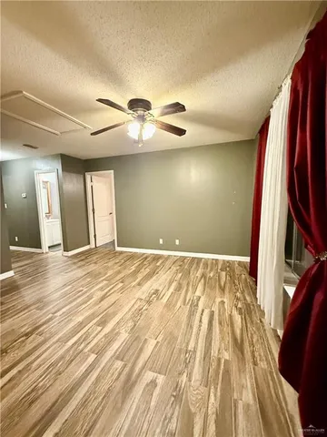 a view of a room with wooden floor and chandelier