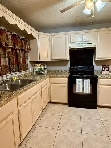 a kitchen with a sink and a stove top oven