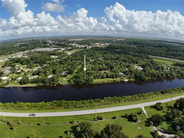 a view of a yard with a wooden fence