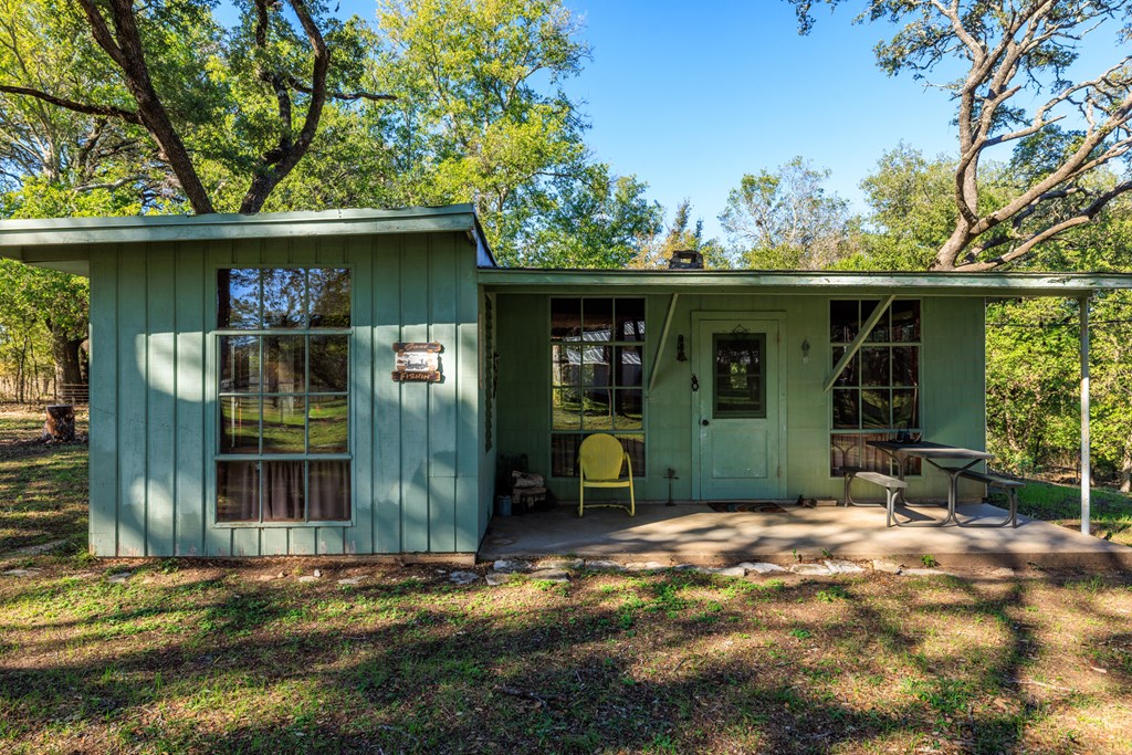 181 Ranch Road 1 Stonewall, TX 78671 - Photo 4 of 11 a front view of a house with garden