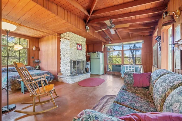 a living room with furniture a fireplace and a table