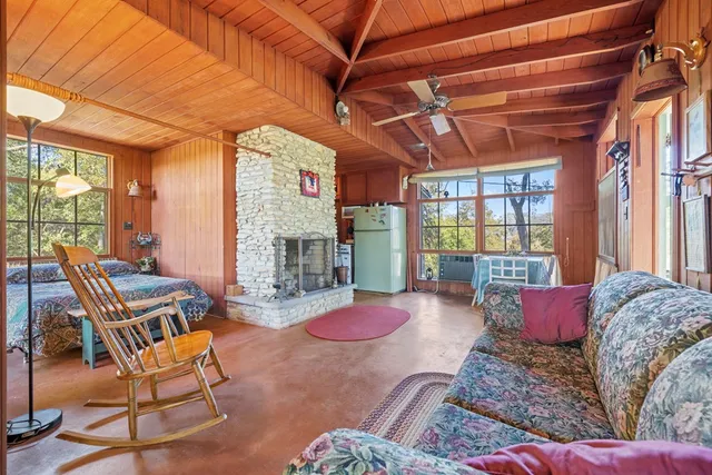 a living room with furniture a fireplace and a table