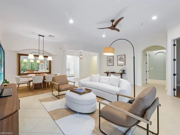 a living room with furniture and a chandelier