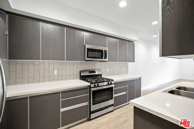 a kitchen with a sink stove and microwave