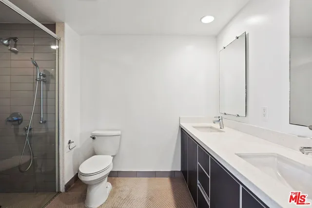 a spacious bathroom with a granite countertop sink a toilet and shower