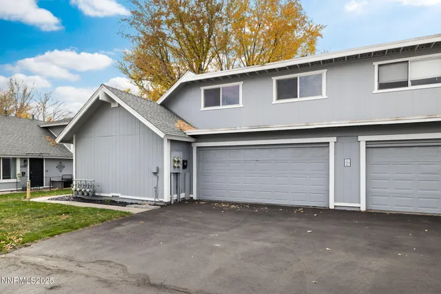 a view of a house with a yard and garage