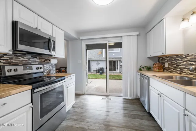 a kitchen with stainless steel appliances a stove microwave and cabinets