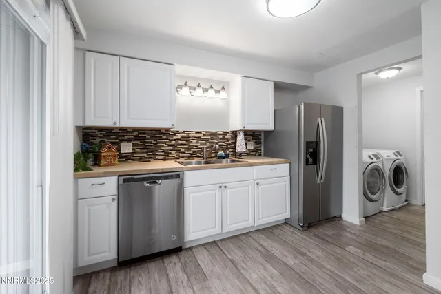 a kitchen with stainless steel appliances granite countertop a refrigerator and a stove top oven