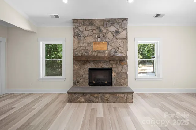a living room with a fireplace and a window