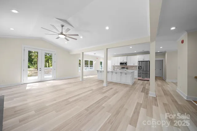 a view of a living room a kitchen and windows