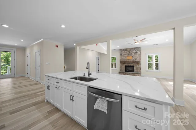 a kitchen with a sink dishwasher a stove and a refrigerator with wooden floor