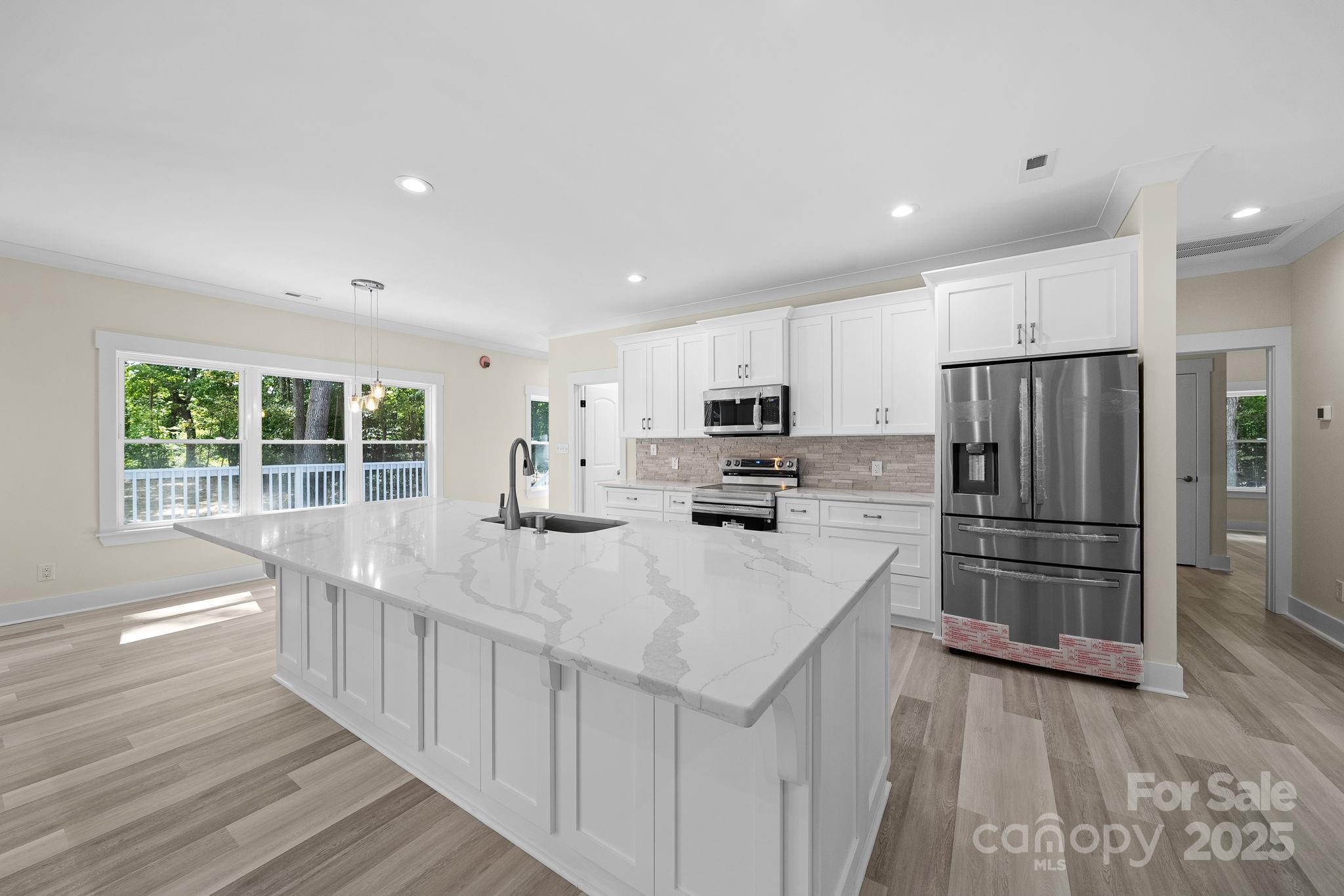 4460 R R L Lane Midland, NC 28107 - Photo 19 of 48 a kitchen with kitchen island a sink appliances and cabinets